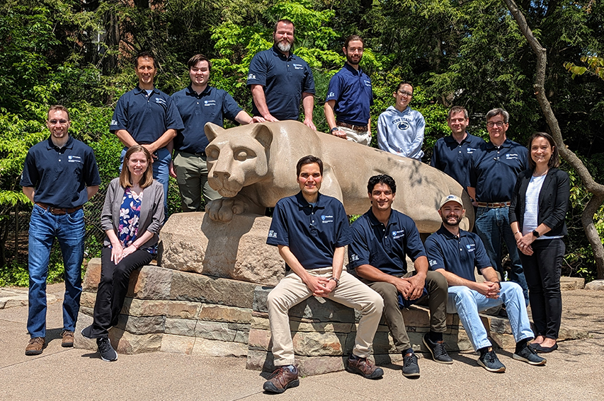 group of people at the nittany lion shrine